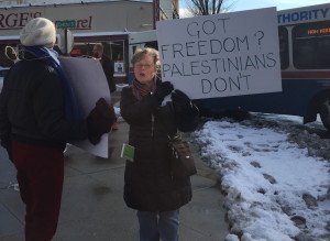 Janet Simmon calls out to passing cars with a fellow protester. Photo by Carrie Giddins Pergram