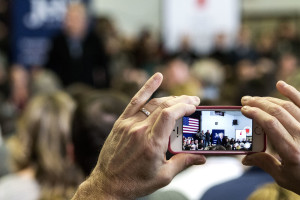 A woman records former governor Jeb Bush's speech in Bedford, NH. Photo by Anna Sortino. 
