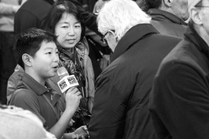 A young boy conducts an interview for "News Kids". Photo by Anna Sortino. 