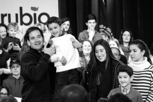 Sen. Rubio lifts up his youngest son to introduce him to the audience. Photo by Anna Sortino. 