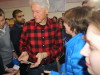 Former president Bill Clinton greets supporters at a Hillary for America rally at Milford Middle School in New Hampshire, while presidential candidate Hillary Clinton helps with the water crisis in Flint, Michigan. Photo by Sharon Lee