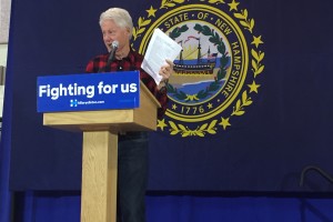 President Clinton shows the audience a copy of an email he received specifying why