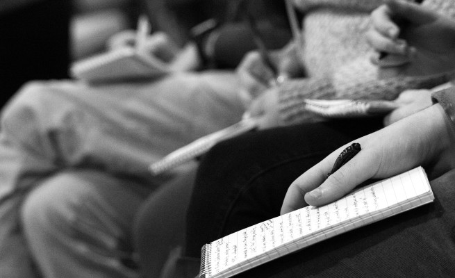 Students write down notes. Photo by Anna Sortino.