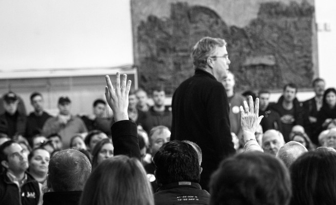 Audience members raise their hands for the chance to ask former governor Jeb Bush a question. Photo by Anna Sortino