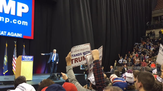 Donald Trump thanks a crowd of nearly 5,000 at the Verizon Wireless Arena in Manchester the night before the primary. Photo by Kyle VonEnde